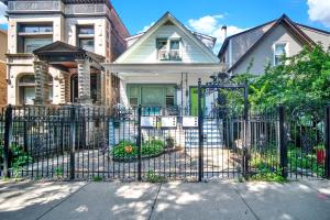 a black fence in front of a house at Logan Square Coach House in Chicago