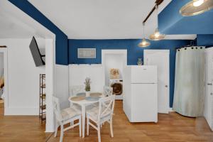 een eetkamer met blauwe muren en een tafel en stoelen bij Logan Square Coach House in Chicago