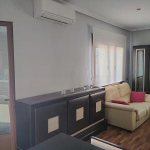 a living room with a couch and a window at vivienda rural AZALEA in Cortijos Nuevos