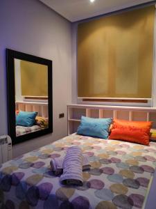 a bedroom with a bed with a large mirror at vivienda rural AZALEA in Cortijos Nuevos