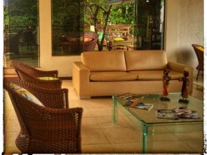 uma sala de estar com um sofá e uma mesa de vidro em Hotel Pedra da Concha em Salvador