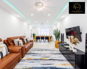 a living room with a couch and a tv at Luxury Home by AV Stays Short Lets Sidcup in Sidcup