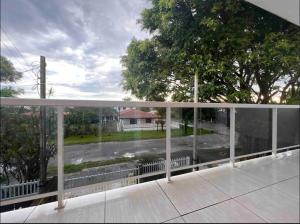 a view from the balcony of a house in the rain at Residencial Passos in Guaratuba