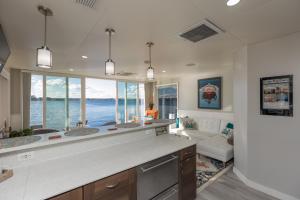 a kitchen with two sinks and a large window at New Floating Luxury: Unique Houseboat Retreat in Fleming Island