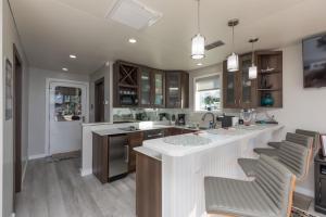 a kitchen with a large white island with bar stools at New Floating Luxury: Unique Houseboat Retreat in Fleming Island
