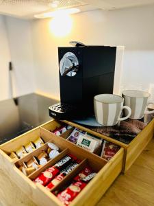 a drawer with a coffee maker and cups on a counter at Apartment MILA in Sankt Peter