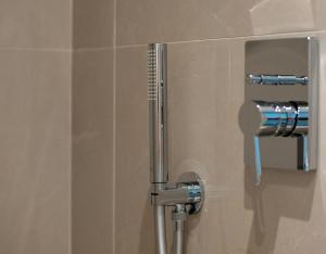 a shower stall in a bathroom with a toilet at G Mare Boutique Hotel in Neos Marmaras +47 photos