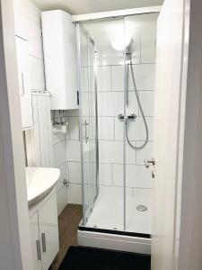 a bathroom with a shower and a sink at Apartment MILA in Sankt Peter