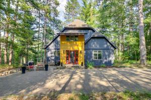 a tiny house in the middle of a forest at Thunder Lake Escape and Boat Dock! in Remer