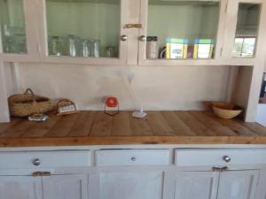 a kitchen with white cabinets and a wooden counter top at AGAVE HOUSE in Prince Albert +42 photos