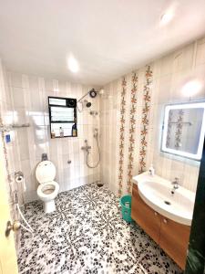 a bathroom with a toilet and a sink at Coco Loco Colva in Colva