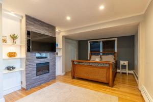 a bedroom with a bed and a fireplace at H2 1 Bedroom Downtown Stamford in Stamford