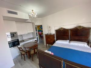 a bedroom with a bed and a kitchen with a table at appartamenti con terrazo solare in Perugia