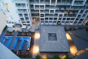 an overhead view of a tall building with a courtyard at 2BR SkyHome at Jade Masdar Oasis in Al Qurayyah