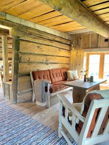 a living room with a couch in a log cabin at Kufjøset in Skjåk