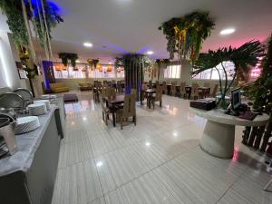 a dining room with tables and chairs in a restaurant at Hotel La Serrania Bucaramanga in Bucaramanga