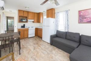 a kitchen and a living room with a couch and a table at Chapel House in Pass Christian