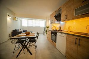 a kitchen with a table and some chairs in a room at 2BR Apartment in Ölüdeniz with Large Pool in Quiet Area in Fethiye