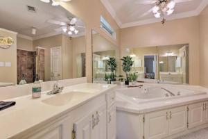 a bathroom with two sinks and a large mirror at 16th and Golden in Diamondhead in Diamondhead +32 photos