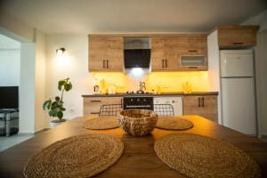 a kitchen with a wooden table with hats on it at 2BR Apartment in Ölüdeniz with Large Pool in Quiet Area in Fethiye +17 photos