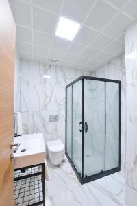 a bathroom with a glass shower and a toilet at İstport Hotels in Arnavutköy