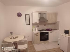 a kitchen with a table and a stove top oven at Dama Apartment in Biograd na Moru
