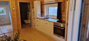 a small kitchen with a sink and a stove at Tinymansion in Brabrand