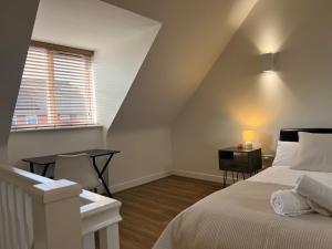 a bedroom with a bed and a desk and a window at Entire House in Littleover Derby in Mickleover