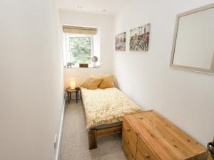 a small bedroom with a bed and a window at Ludd Brook Cottage in Halifax