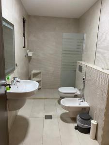 a bathroom with two sinks and a toilet in it at Luxurious Rooftop Appartment in Amman