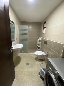 a bathroom with a sink and a toilet at Luxurious Rooftop Appartment in Amman