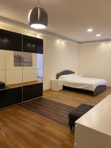 a bedroom with a bed and a glass wall at Luxurious Rooftop Appartment in Amman