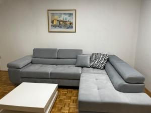 a living room with a gray couch and a table at Apartment 7 in Izola