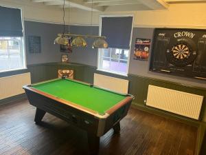 a billiard room with a pool table in it at The Crown Hotel in Southwell