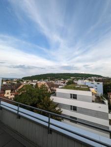 a white building with a view of a city at Modern Roof-Top with Terrace & View in Zurich