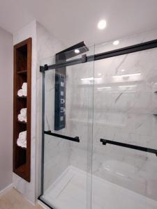 a shower with a glass door in a bathroom at Chalet Escapade Orford in Orford