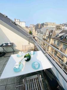 a table on a balcony with a view of a city at Charming Apartments in City Center - S6 in Luxembourg