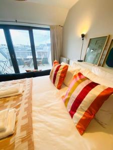 a large bed in a room with a large window at Charming Apartments in City Center - S6 in Luxembourg