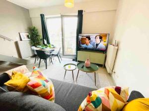 a living room with a couch and a flat screen tv at Charming Apartments in City Center - S6 in Luxembourg