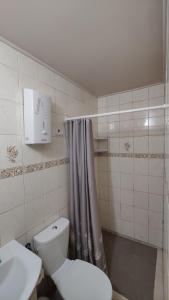 a bathroom with a toilet and a shower curtain at Wilcza Jama in Downary-Plac +20 photos