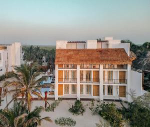 an aerial view of a building with a palm tree at Hotel Panamera in Tulum