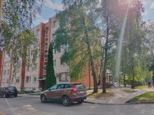 a car parked on a street in front of a building at Rokiskis- jaukus butas su balkonu in Rokiškis
