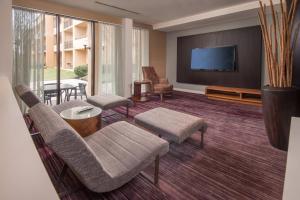 un soggiorno con divano, sedie e TV di Courtyard by Marriott Fairfax Fair Oaks a Fairfax