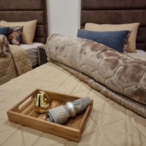 a bed with a tray and a tray of items on it at Appartement de luxe bord de Mer Essaouira à 2 pas de la plage in Essaouira