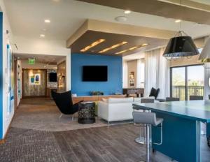 eine Lobby mit einem Wohnzimmer mit blauer Wand in der Unterkunft Luxury Midrise mins away from Medical Center, Toyota Center, Minute Maid and NRG in Houston