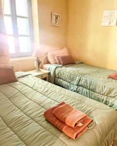 a bedroom with two beds with towels on them at Holiday House Prodromos in Prodromos