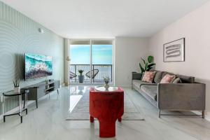 a living room with a couch and a table at Brickell Bay View Oasis with Pool Hot Tub and Gym in Miami