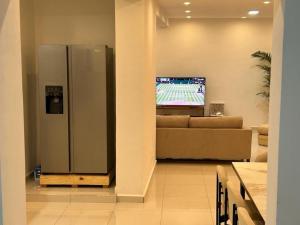 a large stainless steel refrigerator in a living room at Villa d'exception à 20 min de l'aéroport 