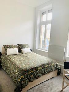 Postel nebo postele na pokoji v ubytování Joli 2 pièces au coeur de Meaux