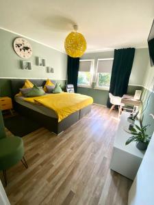 um quarto com uma cama com uma colcha amarela em Daheim in Essen em Essen